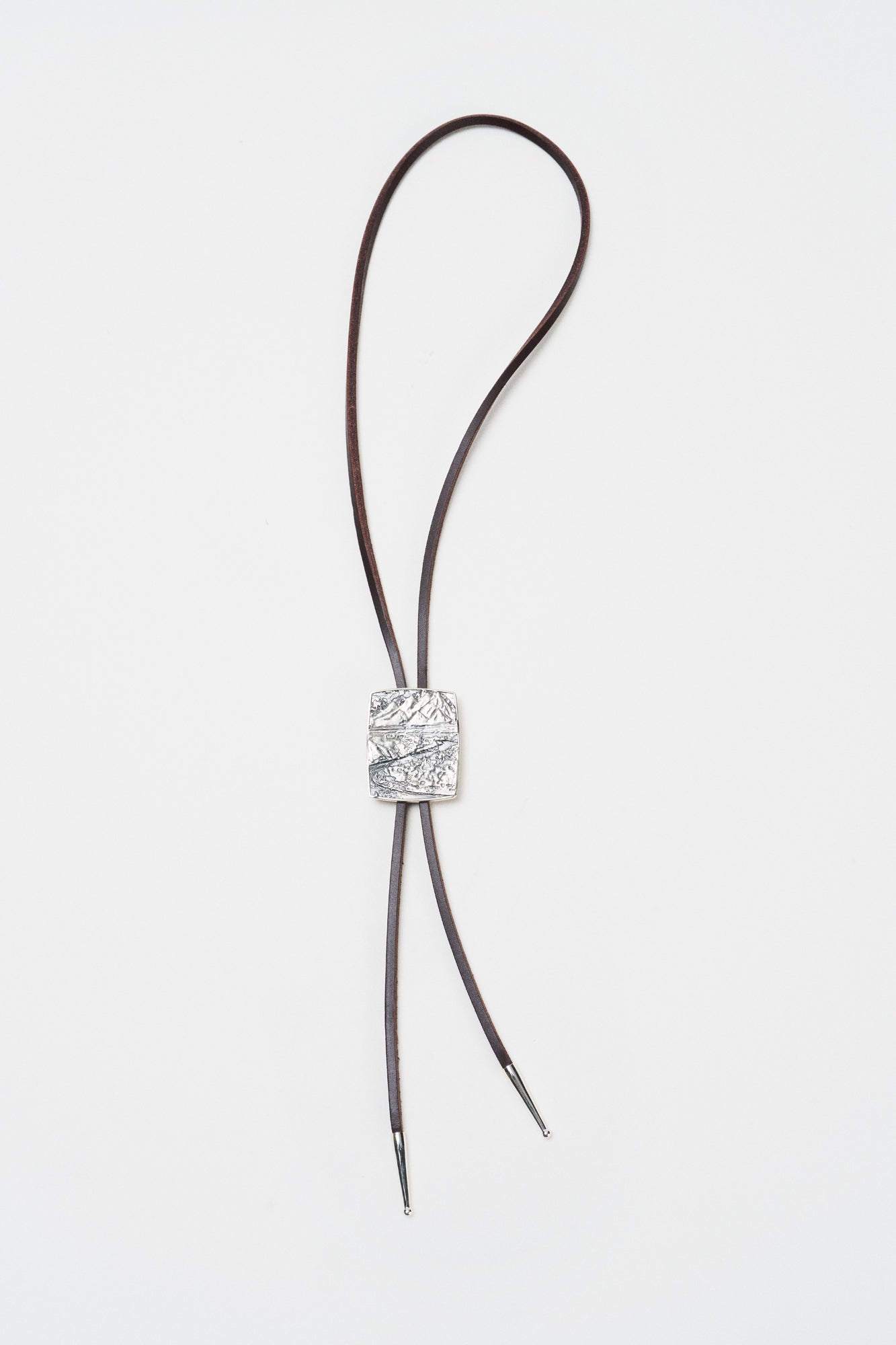 Snake River Bolo Tie by O.P Jewellery featuring a recycled 925 silver landscape slide on a dark leather cord.
