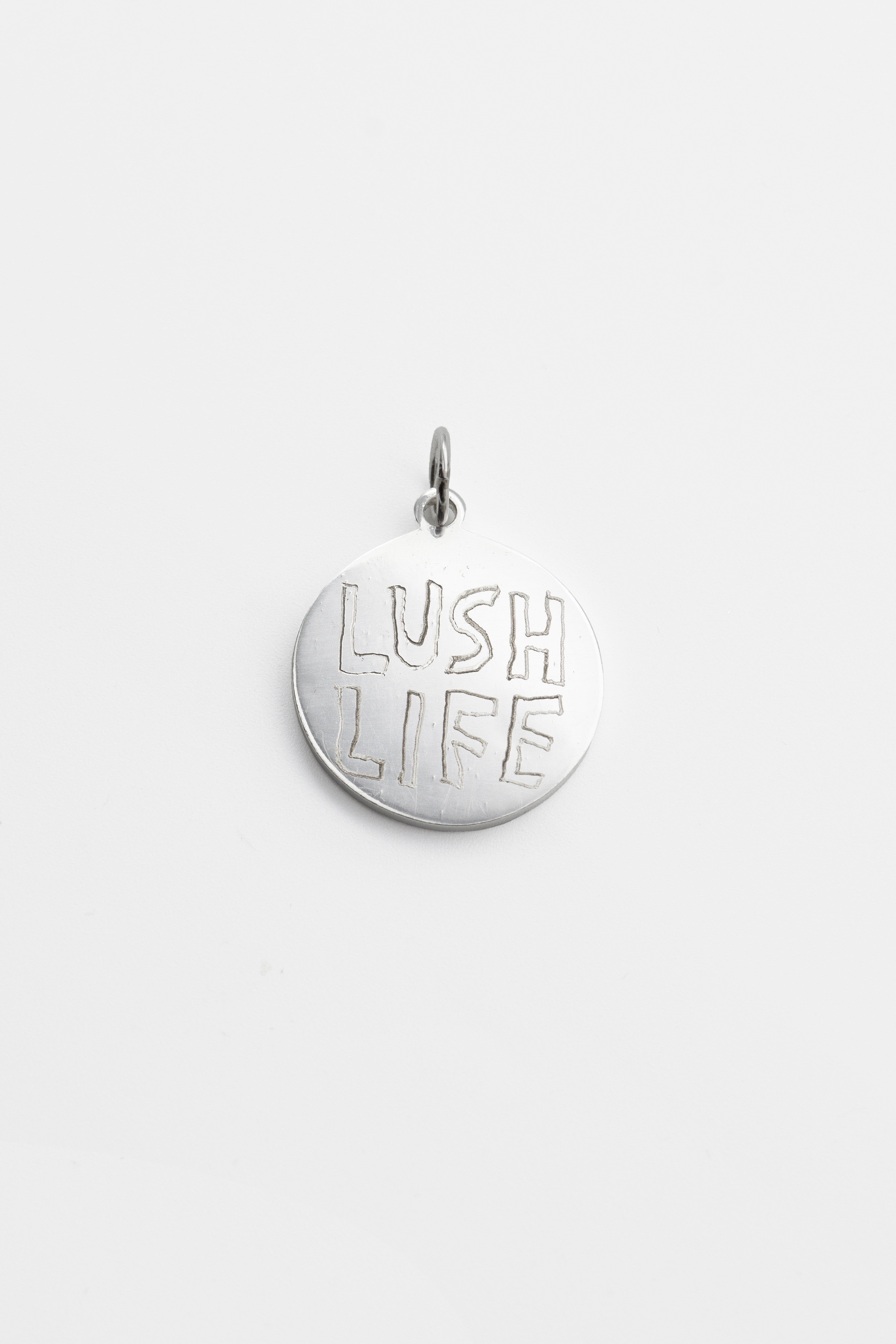 O.P Jewellery 999 silver pendant from Niklas Hallberg, featuring a hand-engraved LUSH LIFE design.