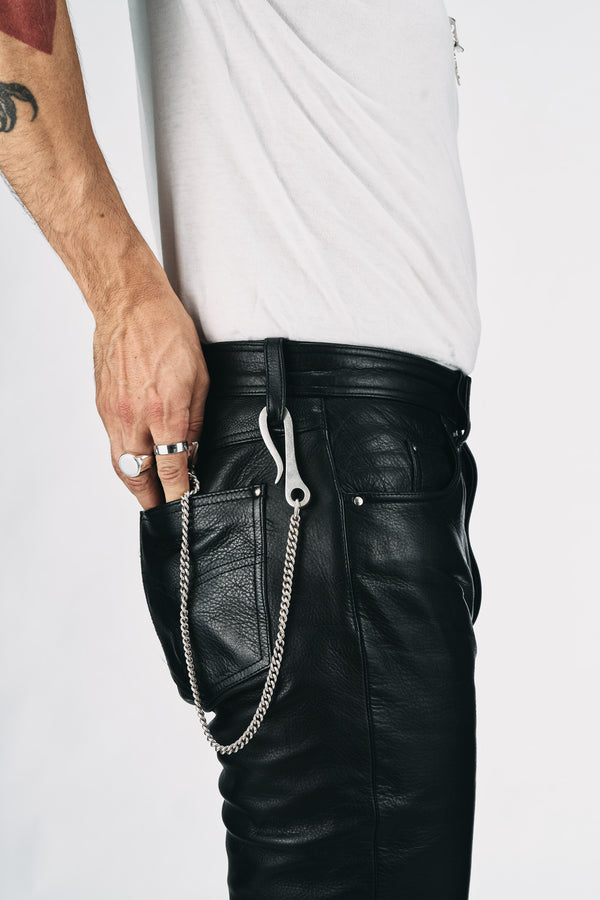 O.P Jewellery Union Key Hook in recycled silver, attached to black leather trousers with a wallet chain and rings.